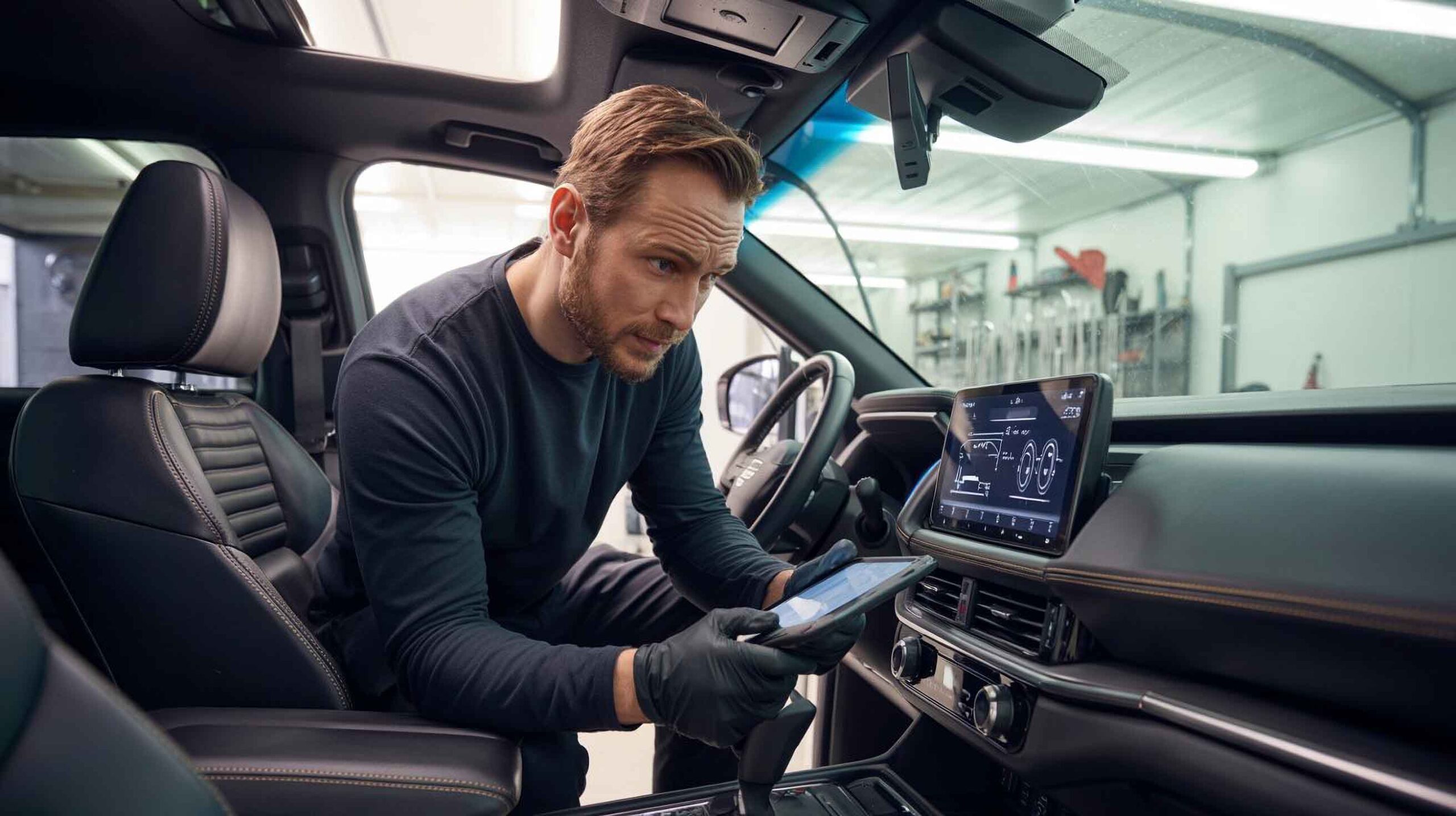 Technician with tablet inside vehicle running calibration – ADAS Services – Craigs Collision Technician with tablet inside vehicle running calibration - ADAS Services - Craigs Collision