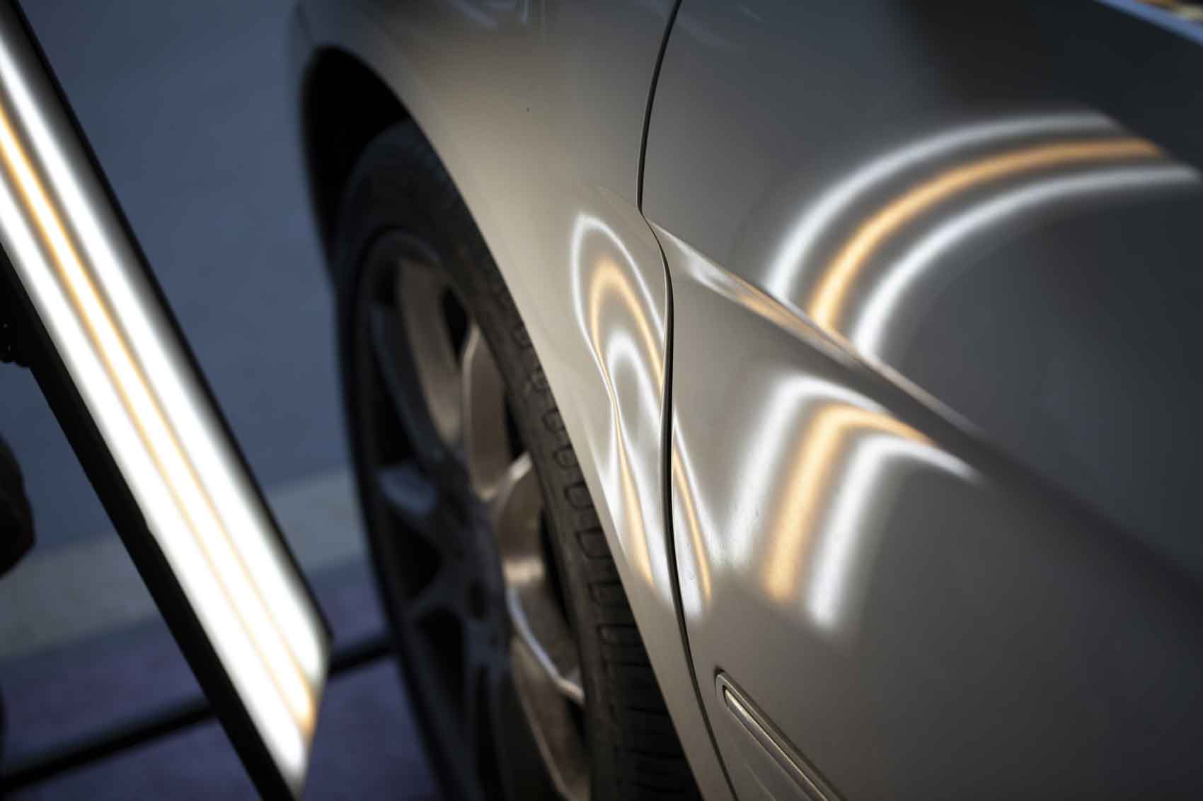 silver vehicle with lights on body panels - paintless dent repair - craigs collision